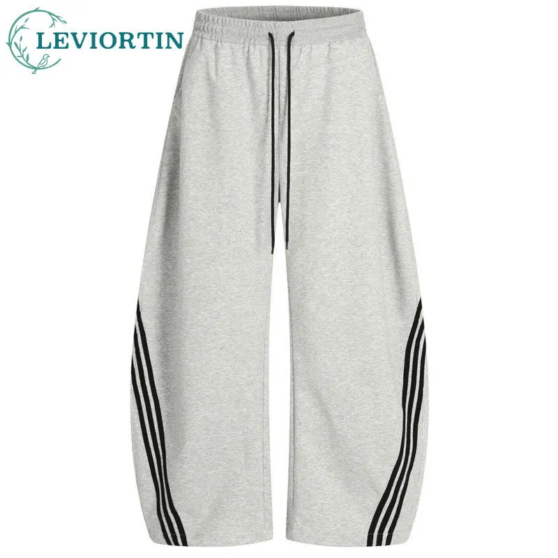 Men's trendy streetwear style, loose and casual splicing, three bar design, sporty wide leg silhouette, curved knife pants